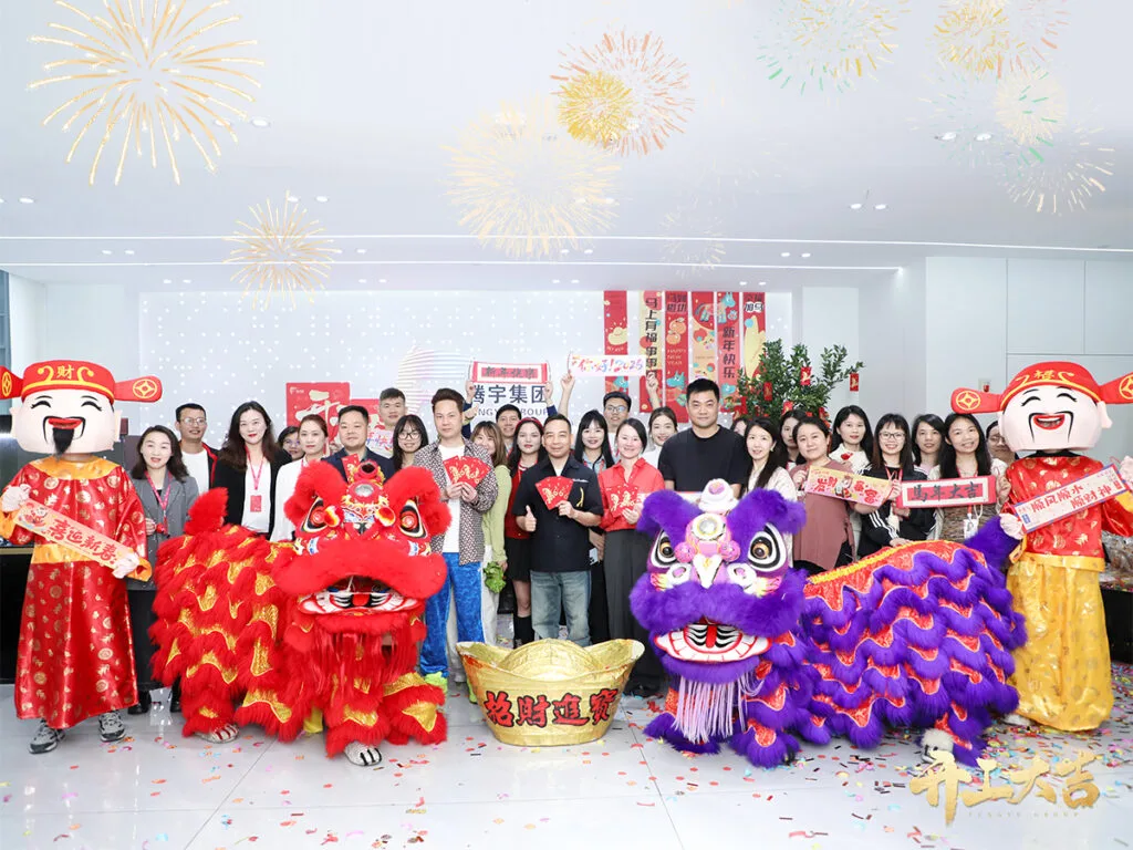 Team members and lion dancers celebrating the new year at the factory