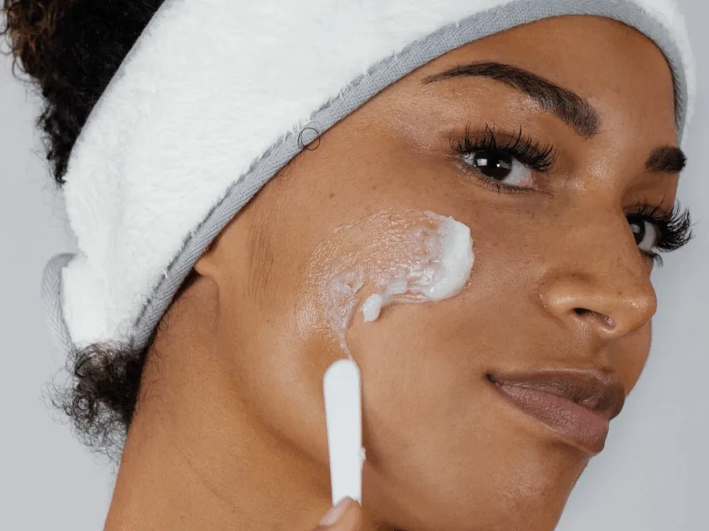Woman applying cleansing balm