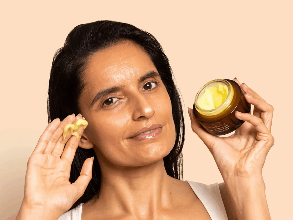 Woman using cleansing balm
