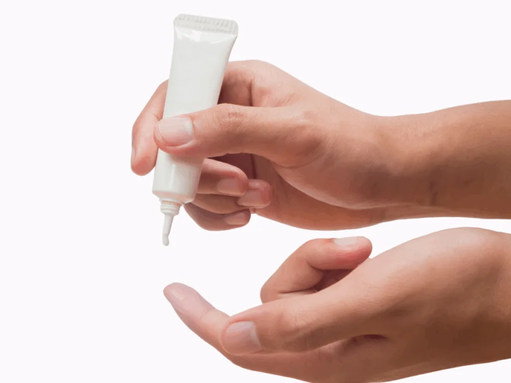 A hand applying skincare cream